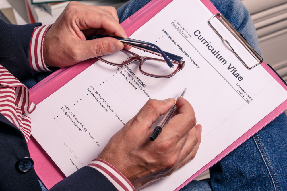 Man holding a blank CV