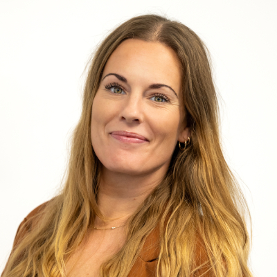 Portrait of smiling woman with long dark blonde hair
