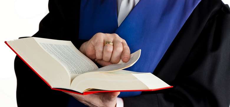 utsnitt av en person med advokatkappe som older Norges lover